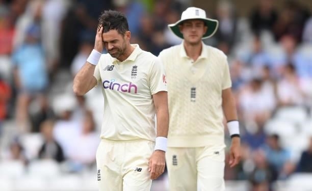 James Anderson of England reacts with Stuart Broad looking on during the third day of the 1st LV= Test match between England and India at Trent...