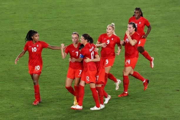 Jessie Fleming of Team Canada celebrates with team mates after scoring their side's first goal during the Women's Gold Medal Match between Canada and...
