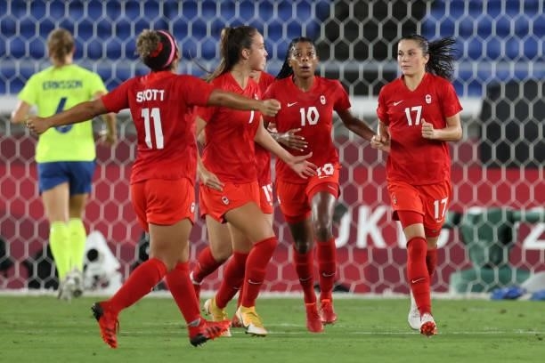 Jessie Fleming of Team Canada celebrates with teammates after scoring their team's first goal during the Women's Gold Medal Match between Canada and...