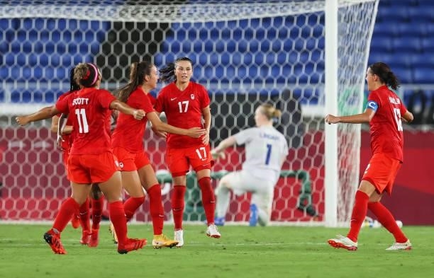 Jessie Fleming of Team Canada celebrates with Julia Grosso and teammates after scoring their team's first goal during the Women's Gold Medal Match...