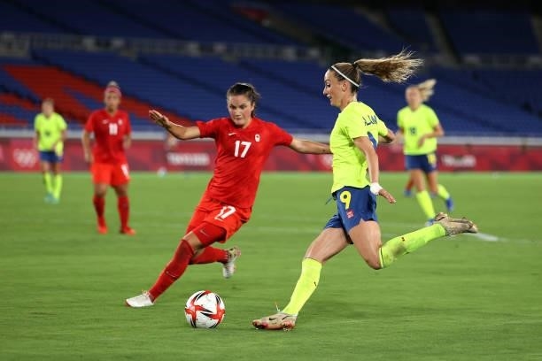 Kosovare Asllani of Team Sweden crosses the ball whilst under pressure from Jessie Fleming of Team Canada during the Women's Gold Medal Match between...
