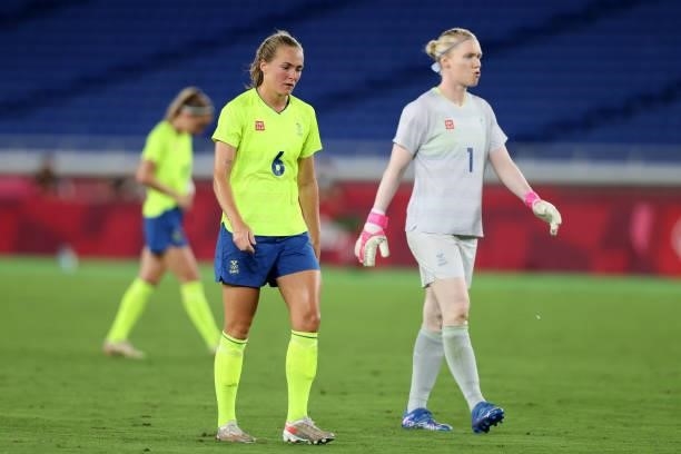 Magdalena Eriksson and Hedvig Lindahl of Team Sweden look dejected after conceding a penalty kick which is later scored by Jessie Fleming of Team...