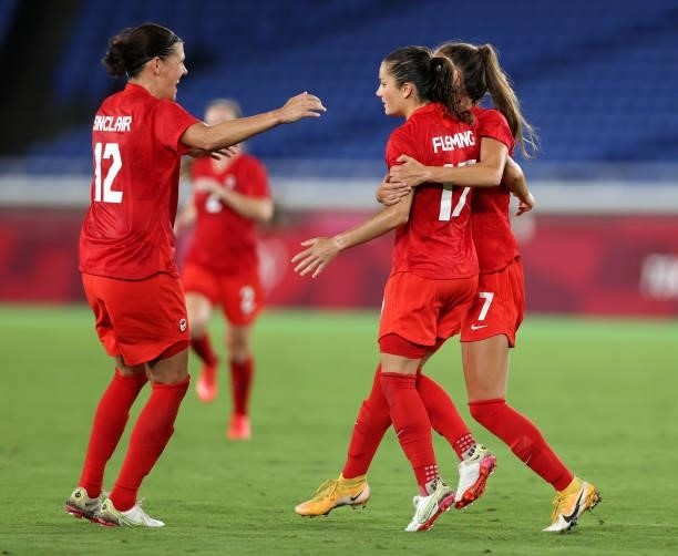 Jessie Fleming of Team Canada celebrates with Julia Grosso and Christine Sinclair after scoring their side's first goal during the Women's Gold Medal...
