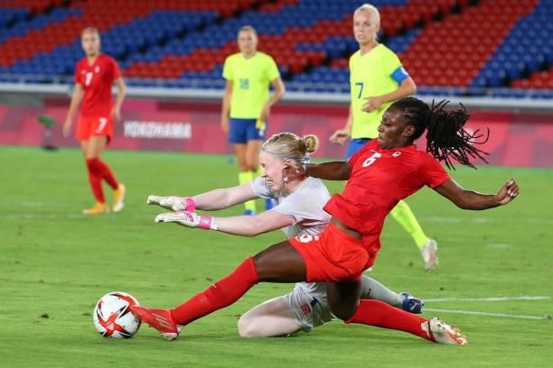 Hedvig Lindahl of Team Sweden and Deanne Rose of Team Canada compete for the ball during the Women's Gold Medal Match between Canada and Sweden on...