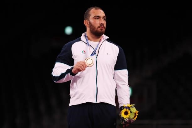 Bronze medalist Amir Hossein Zare of Team Iran poses with the bronze medal during the Men's Freestyle 125kg medal ceremony on day fourteen of the...