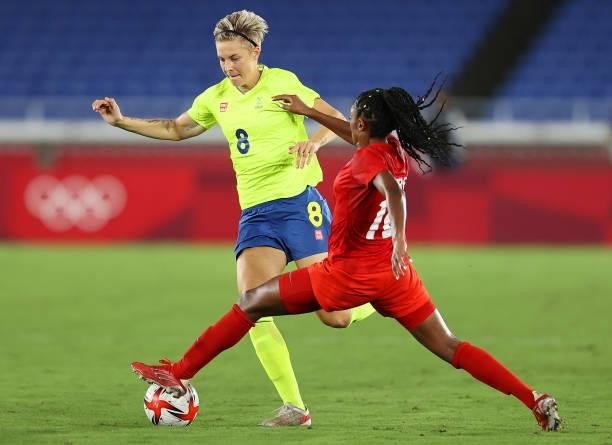 Lina Hurtig of Team Sweden evades a tackle by Ashley Lawrence of Team Canada during the Women's Gold Medal Match between Canada and Sweden on day...