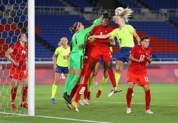 Amanda Ilestedt of Team Sweden competes for a header with Stephanie Labbe Kadeisha Buchanan of Team Canada during the Women's Gold Medal Match...