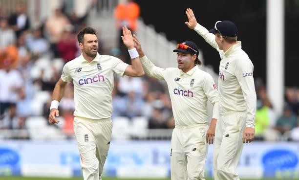 James Anderson of England celebrates with Rory Burns and Zak Crawley after getting Shardul Thakur of India out during day three of the First Test...