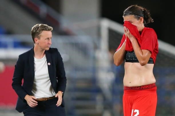 Christine Sinclair of Team Canada reacts as she walks off the pitch after being substituted off as Bev Priestman, Head Coach of Team Canada looks on...