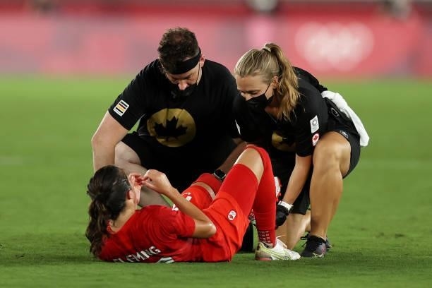 Jessie Fleming of Team Canada receives medical treatment during the Women's Gold Medal Match between Canada and Sweden on day fourteen of the Tokyo...