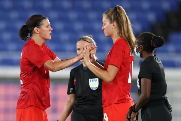 Christine Sinclair of Team Canada embraces teammate Jordyn Huitema as she is substituted off during the Women's Gold Medal Match between Canada and...