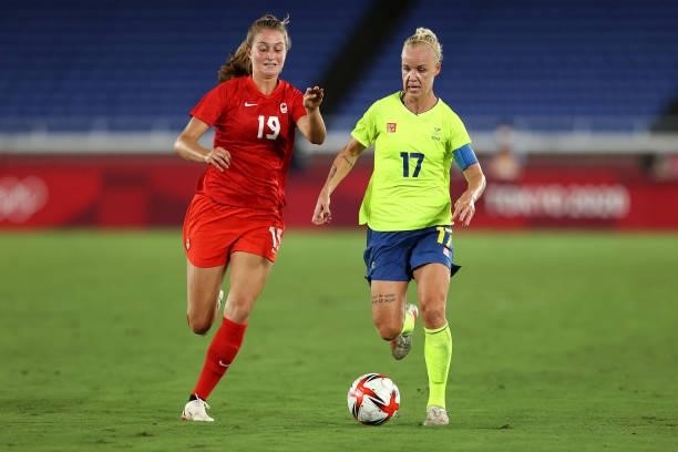Caroline Seger of Team Sweden runs with the ball whilst under pressure from Jordyn Huitema of Team Canada during the Women's Gold Medal Match between...