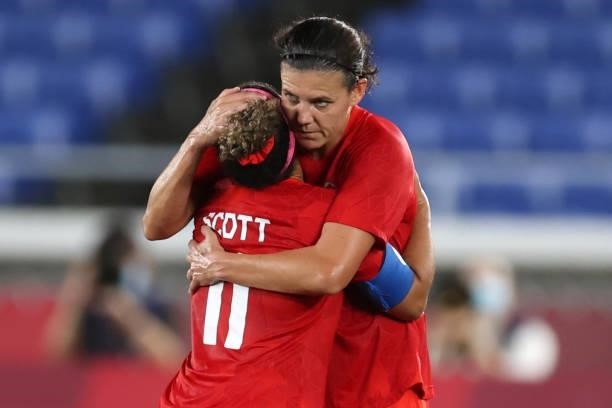 Christine Sinclair of Team Canada embraces teammate Desiree Scott as she is substituted off during the Women's Gold Medal Match between Canada and...