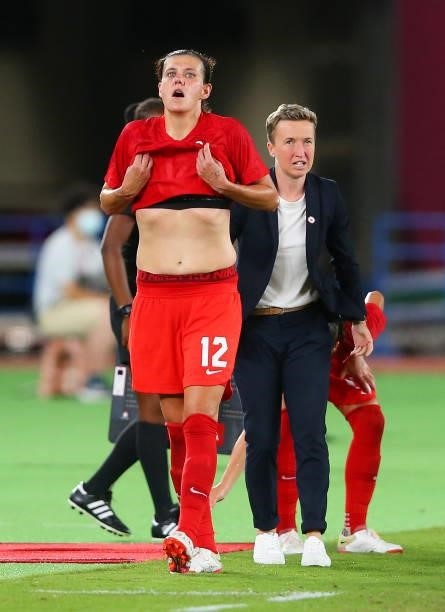 Christine Sinclair of Team Canada interacts with Bev Priestman, Head Coach of Team Canada as she is substituted off during the Women's Gold Medal...