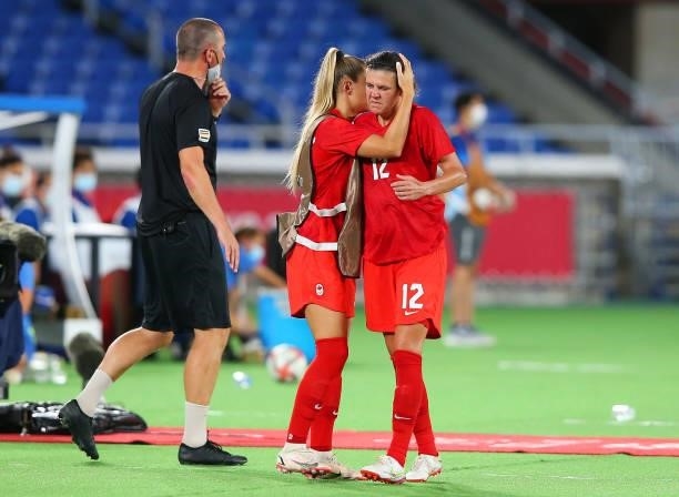 Christine Sinclair of Team Canada is embraced by a teammate as she is substituted off during the Women's Gold Medal Match between Canada and Sweden...