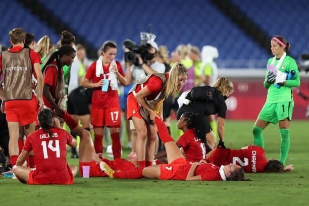 Julia Grosso of Team Canada receives treatment for cramp during a drinks break ahead of extra-time during the Women's Gold Medal Match between Canada...