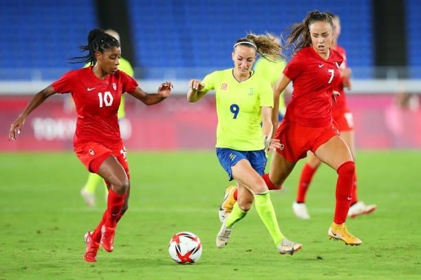 Kosovare Asllani of Team Sweden battles for possession with Ashley Lawrence and Julia Grosso of Team Canada during the Women's Gold Medal Match...