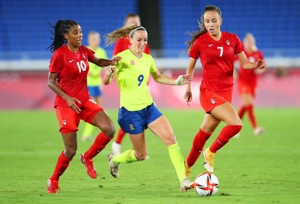 Kosovare Asllani of Team Sweden battles for possession with Ashley Lawrence and Julia Grosso of Team Canada during the Women's Gold Medal Match...