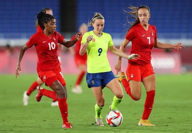 Kosovare Asllani of Team Sweden runs with the ball whilst under pressure from Ashley Lawrence and Julia Grosso of Team Canada during the Women's Gold...
