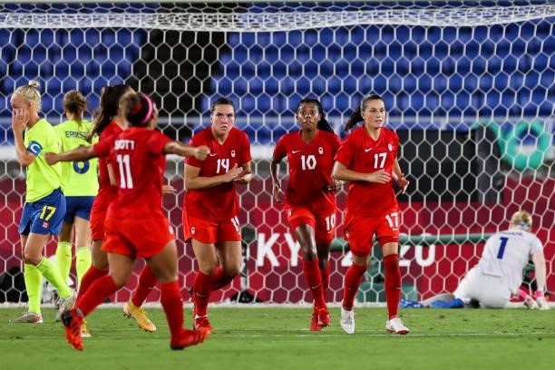 Jessie Fleming of Canada celebrates her goal with teammates during the Olympic women's football gold medal match between Sweden and Canada at...