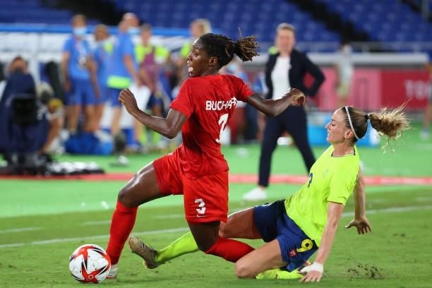 Kadeisha Buchanan of Team Canada and Kosovare Asllani of Team Sweden collide in the first half of extra time during the Women's Football Gold Medal...
