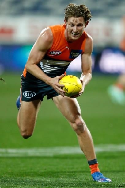 Lachie Whitfield of the Giants runs with the ball during the round 21 AFL match between Geelong Cats and Greater Western Sydney Giants at GMHBA...