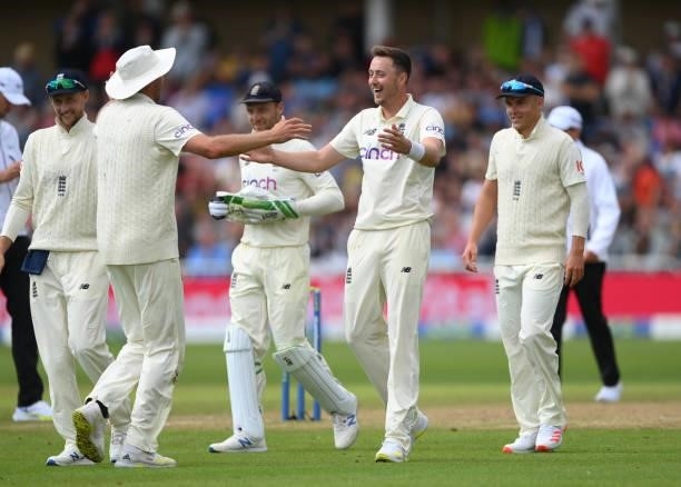 England bowler Ollie Robinson celebrates with Stuart Broad after the pair combined to take the the 5th wicket of India batsmen Jasprit Bumrah during...
