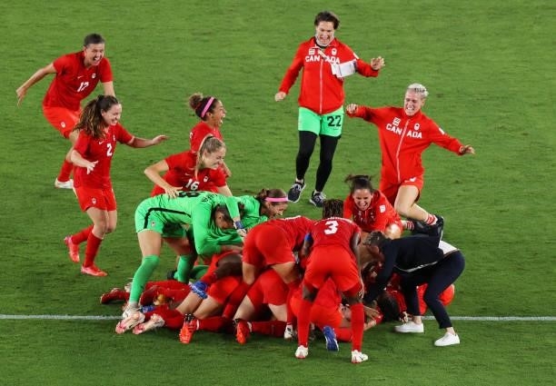 Julia Grosso of Team Canada celebrates with team mates after scoring their sides winning penalty in the penalty shoot out in the Women's Gold Medal...