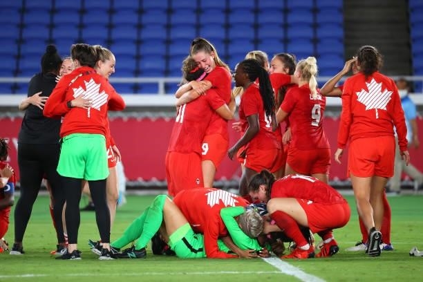 Team Canada celebrates after defeating Team Sweden in a penalty shoot-out to win gold in the women's football gold medal match between Canada and...