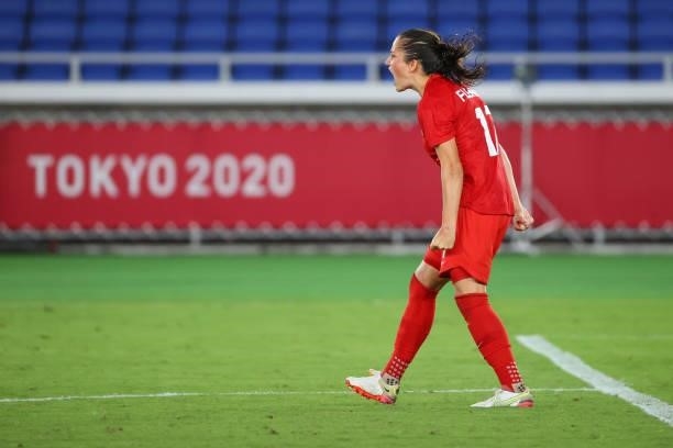 Jessie Fleming of Team Canada celebrates after making her shot during the penalty kick shoot-out during the women's football gold medal match between...