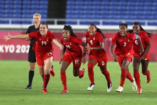 Vanessa Gilles, Ashley Lawrence, Jayde Riviere, Kadeisha Buchanan and Deanne Rose of Team Canada celebrate following their team's victory in the...