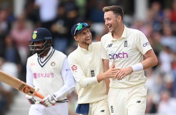 Ollie Robinson of England celebrates with Joe Root after dismissing Jasprit Bumrah of India and claiming his fifth wicket during the third day of the...
