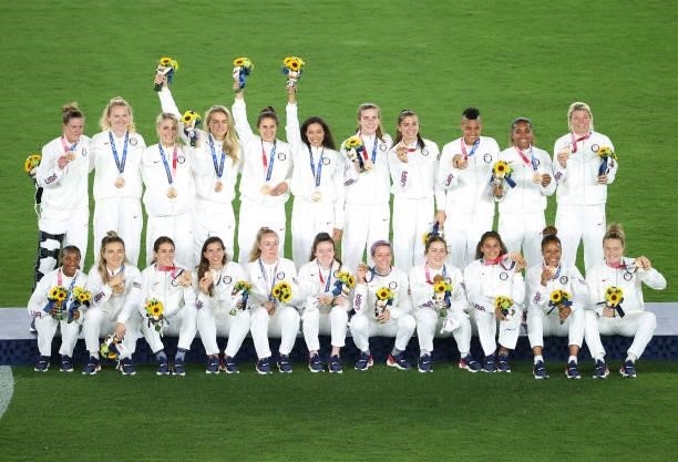 Bronze medalists of Team United States pose with their bronze medals during the Women's Football Competition Medal Ceremony on day fourteen of the...