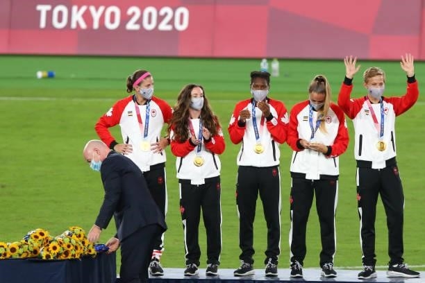 Gold medalist Quinn of Team Canada waves after receiving their gold medal during the Women's Football Competition Medal Ceremony on day fourteen of...
