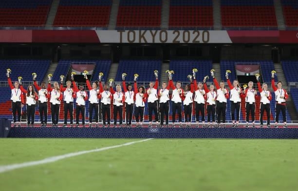 Gold medalist Christine Sinclair and teammates of Team Canada celebrate with their gold medals on the podium during the Women's Football Competition...