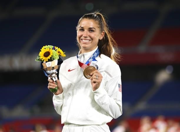 Bronze medalist Alex Morgan of Team United States poses with their bronze medal during the Women's Football Competition Medal Ceremony on day...