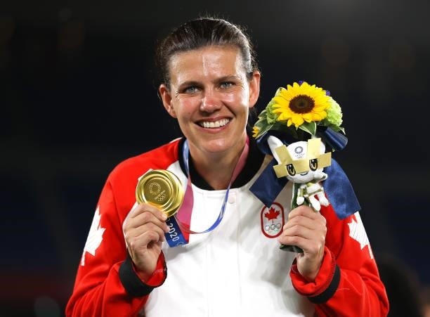 Gold medalist Christine Sinclair of Team Canada poses with her gold medal during the Women's Football Competition Medal Ceremony on day fourteen of...