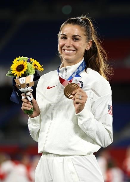 Bronze medalist Alex Morgan of Team United States poses with their bronze medal during the Women's Football Competition Medal Ceremony on day...