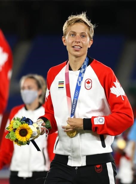 Gold medalist Quinn of Team Canada looks on with their gold medal during the Women's Football Competition Medal Ceremony on day fourteen of the Tokyo...
