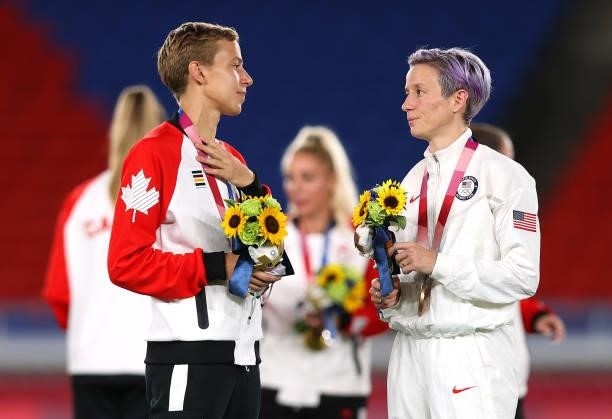 Gold medalist Quinn of Team Canada interacts with Bronze medalist Megan Rapinoe of Team United States during the Women's Football Competition Medal...