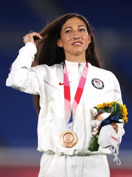 Bronze medalist Christen Press of Team United States looks on with her bronze medal during the Women's Football Competition Medal Ceremony on day...