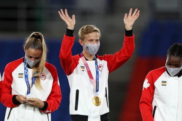 Gold medalist Quinn of Team Canada waves with their gold medal during the Women's Football Competition Medal Ceremony on day fourteen of the Tokyo...