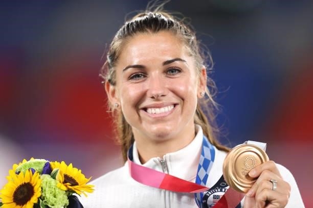 Bronze medalist Alex Morgan of Team USA poses with her bronze medal during the Women's Football Competition Medal Ceremony on day fourteen of the...
