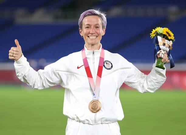 Bronze medalist Megan Rapinoe of Team USA poses with her bronze medal during the Women's Football Competition Medal Ceremony on day fourteen of the...
