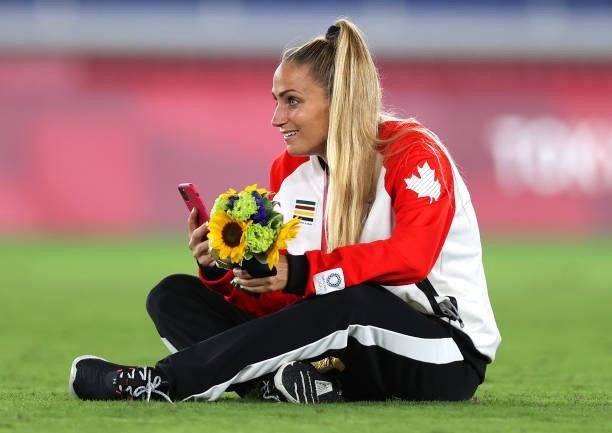 Gold medalist Shelina Zadorsky of Team Canada reacts with her gold medal during the Women's Football Competition Medal Ceremony on day fourteen of...