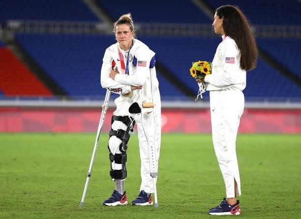 Bronze medalist Alyssa Naeher of Team United States reacts with her bronze medal as she interacts with Christen Press of Team United States during...