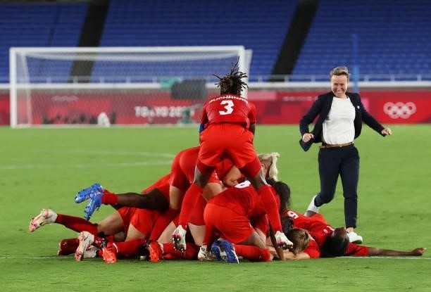 Kadeisha Buchanan of Team Canada and teammates celebrate their team's victory in the penalty shootout during the Women's Gold Medal Match between...