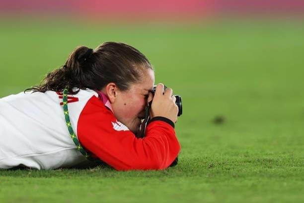 Jessie Fleming of Team Canada takes a photograph during the Women's Football Competition Medal Ceremony on day fourteen of the Tokyo 2020 Olympic...
