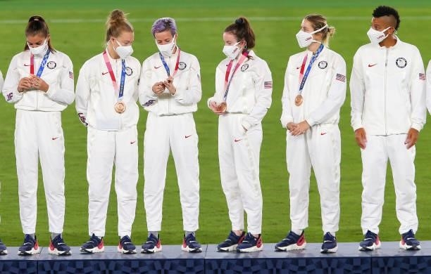 Bronze medalist Megan Rapinoe and teammates of Team United States celebrate with their bronze medals on the podium during the Women's Football...