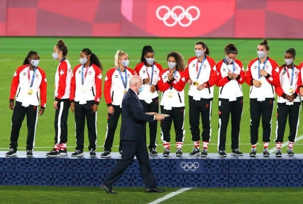 Gianni Infantino, President of FIFA carries out the medals past gold medalists Team Canada during the Women's Football Competition Medal Ceremony on...